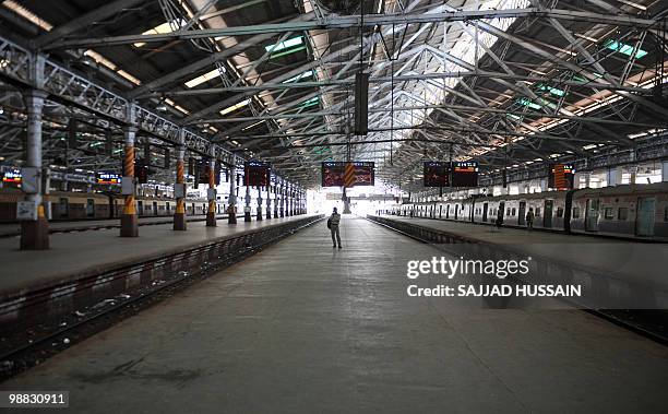 Commuter walks through the Chhrapati Shivaji Terminus in Mumbai on May 4, 2010. Striking train drivers in Mumbai brought chaos to the congested...