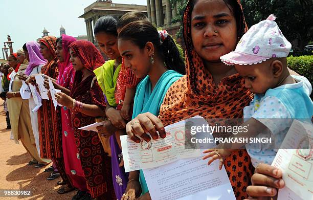 Survivors of 1984's Union Carbide disaster in Bhopal hold placards as they gather outside the Indian Prime Minister's office to file a Right To...