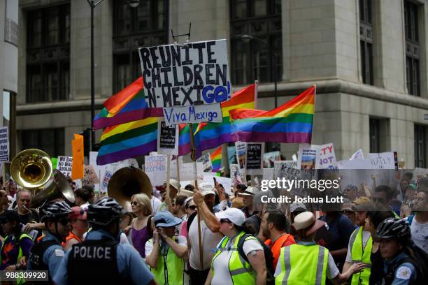 Counter protester stands with demonstrators protesting against Immigration and Customs Enforcement and the Trump administration's immigration...