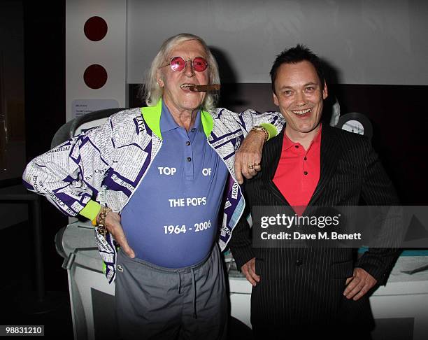 Former DJ and Top of The Pops presenter Sir Jimmy Savile and TV presenter Terry Christian attend the launch party for the "My Generation" Book Launch...