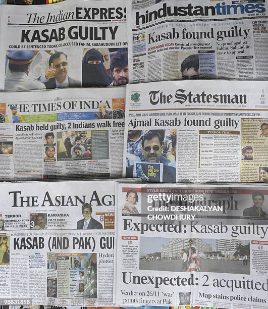 Various Indian newspapers carry the front-page story of convicted 2008 Mumbai attacks gunman Mohammed Ajmal Amir Kasab in Kolkata on May 4, 2010. An...