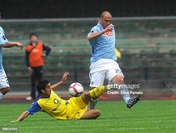 Paolo Cannavaro of Napoli tackles Giampiero Pinzi of Chievo during the Serie A match between Chievo and Napoli at Stadio Marc'Antonio Bentegodi on...