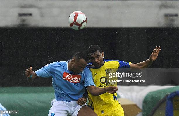 Camilo Zuniga of Napoli tackles Marcos De Paula of Chievo during the Serie A match between Chievo and Napoli at Stadio Marc'Antonio Bentegodi on May...