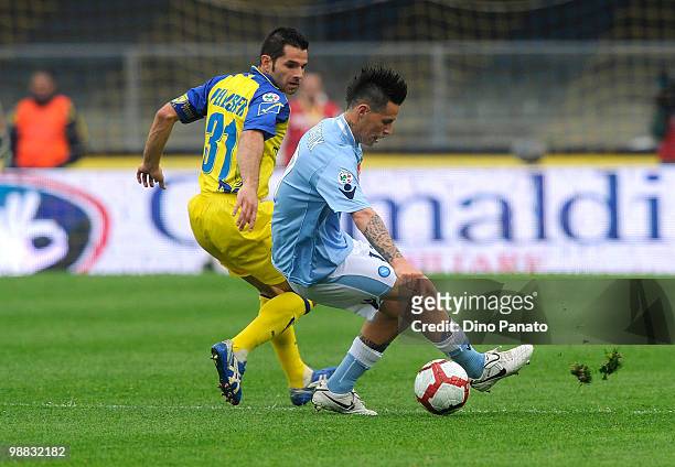 Marek Hamsik of Napoli tackles Sergio Pellissier of Chievo during the Serie A match between Chievo and Napoli at Stadio Marc'Antonio Bentegodi on May...