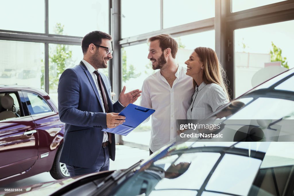 Young couple buying a car