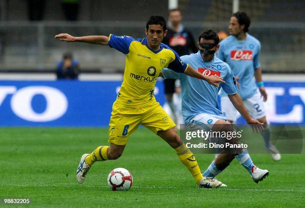 Michele Pazienza of Napoli wearing a protective mask tackles Giampiero Pinzi of Chievo during the Serie A match between Chievo and Napoli at Stadio...