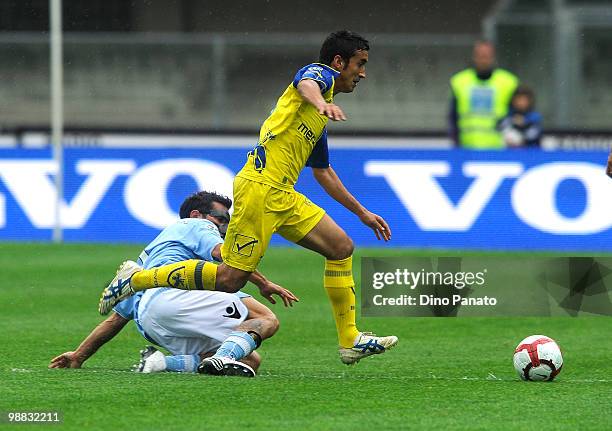 Michele Pazienza of Napoli wearing a protective mask tackles Giampiero Pinzi of Chievo during the Serie A match between Chievo and Napoli at Stadio...