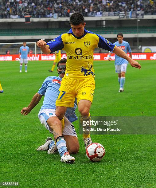 Michele Pazienza of Napoli wearing a protective mask tackles Bojan Jokic of Chievo during the Serie A match between Chievo and Napoli at Stadio...