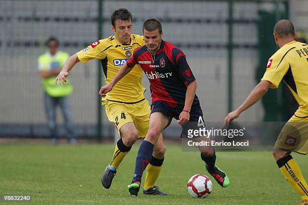 Daniele Dessena of Cagliari and Lukovic Aleksandar of Udinese compete for the ball during the Serie A match between Cagliari and Udinese at Stadio...