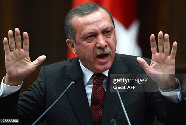 Turkish Prime Minister Tayyip Erdogan addresses parliament members of his ruling Justice and Developement Party at the Turkish Parliament in Ankara...