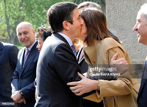 Basque government interior chief Rodolfo Ares smiles as he looks at Basque regional president Patxi Lopez kissing her cabinet's spokeswoman Idoia...