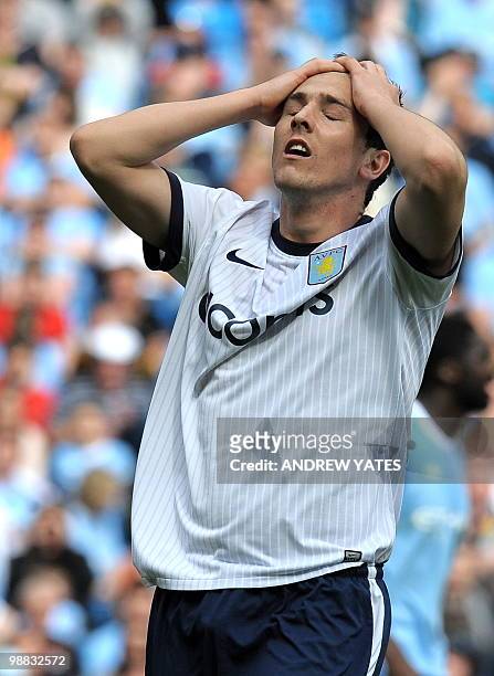 Aston Villa's English midfielder Stewart Downing reacts during the English Premier League football match between Manchester City and Aston Villa at...