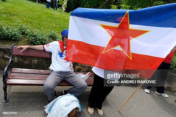 Former Yugoslavia supporters and die-hard fans of Josip Broz Tito display a flag as they wait to pay tribute to the late communist leader on the 30th...