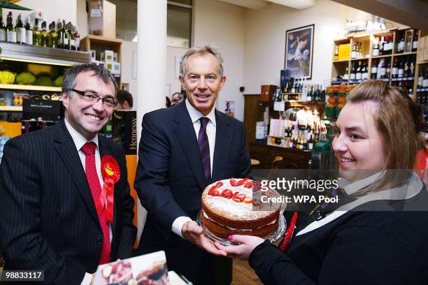 May 04: Former Prime Minister Tony Blair is given a cake by Alex Haigh, watched by Phil Woolas , the Labour candidate for Oldham East and...