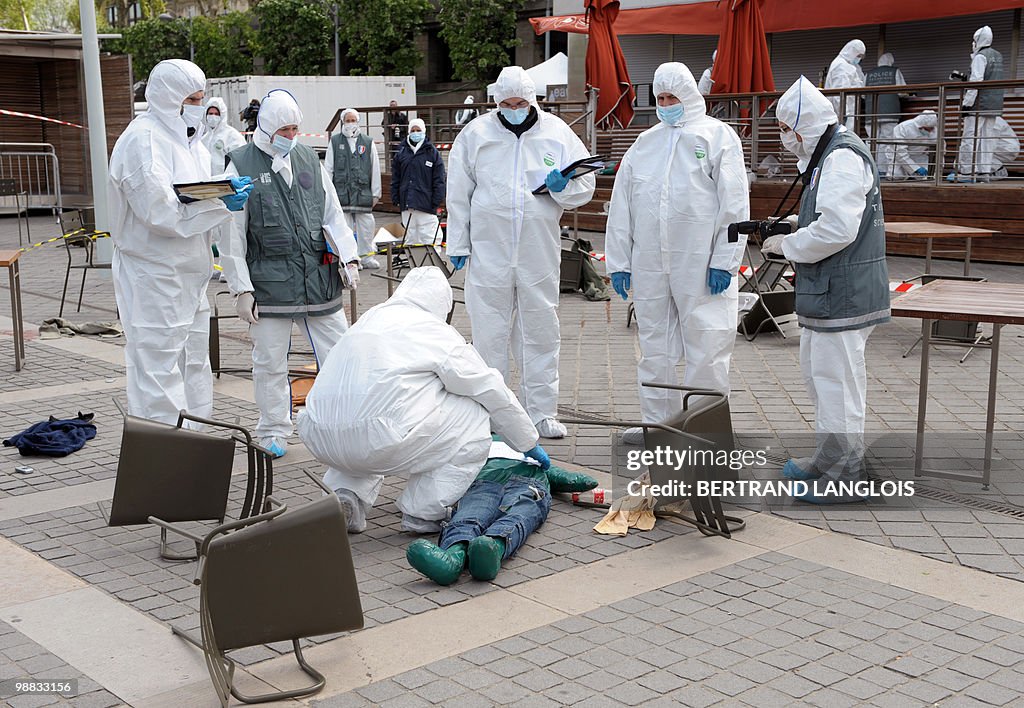 Policemen wearing NBC suits surround a p