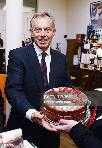 May 04: Former Prime Minister Tony Blair is given a cake by Alex Haigh, watched by Phil Woolas , the Labour candidate for Oldham East and...