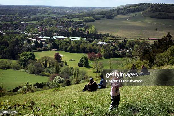 Young girl blows a Dandelion on Box Hill overlooking the Surrey countryside on May 3, 2010 in Dorking, England.