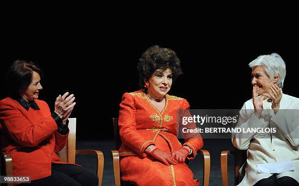 French actresses Francoise Arnoul and Nadine Alari applaud Italian actress Gina Lollobrigida during a ceremony in homage to French legend actor...