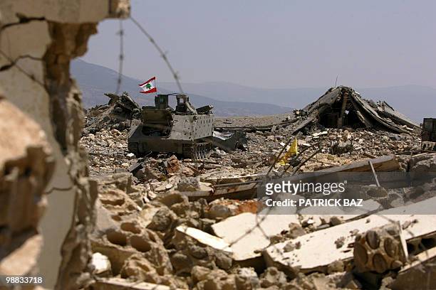File picture dated August 27, 2006 shows a Lebanese flag fluttering on an abandonned Israeli army armored personal carrier amid the ruins of the...