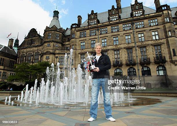 Neil Robertson of Australia poses with the trophy at a photocall after beating Graeme Dott of Scotland to win the Betfred.com World Snooker...