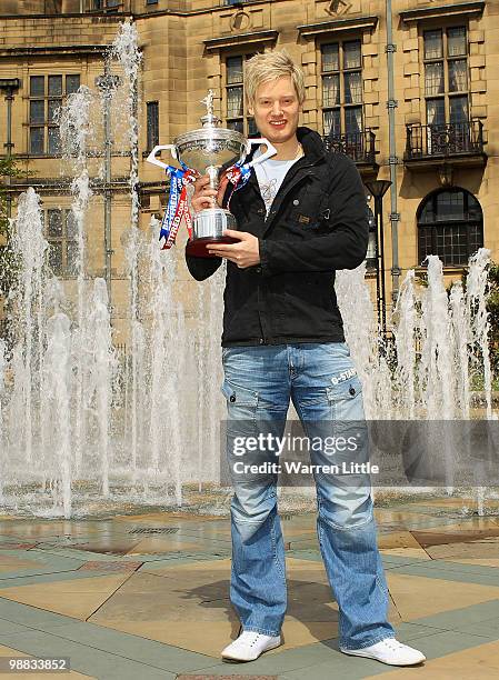 Neil Robertson of Australia poses with the trophy at a photocall after beating Graeme Dott of Scotland to win the Betfred.com World Snooker...