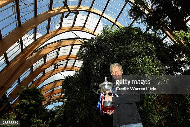 Neil Robertson of Australia poses with the trophy at a photocall after beating Graeme Dott of Scotland to win the Betfred.com World Snooker...