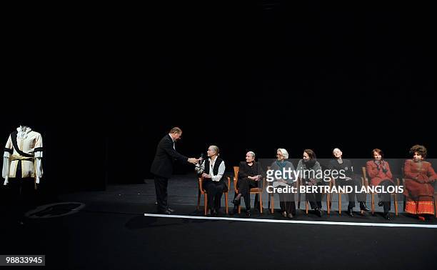 French actor Pierre Santini holds the micro to actress Genevieve Page flanked by other actresses during a ceremony in hommage to French legend actor...