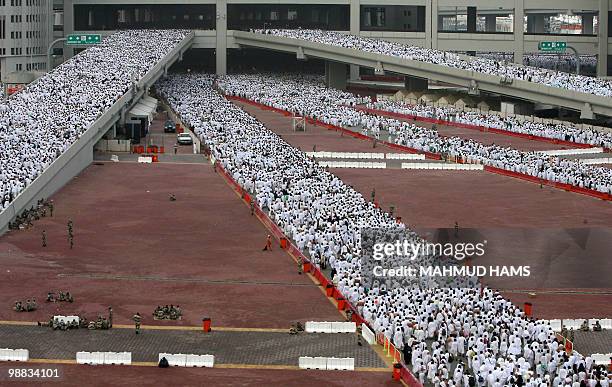 Muslim pilgrims head to perform the "Jamarat" ritual, the stoning of Satan, in Mina near the holy city of Mecca on November 27, 2009. Pilgrims pelted...