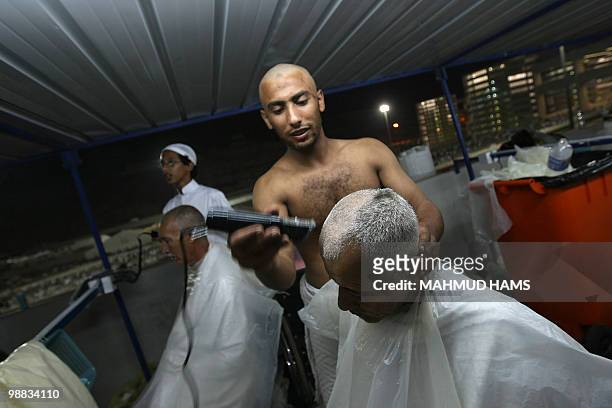 Muslim pilgrims shave their heads after performing the "Jamarat" ritual, the stoning of Satan, in Mina near the holy city of Mecca on November 27,...