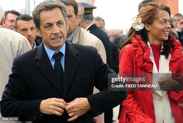 French President Nicolas Sarkozy , next to Teaki Dupont-Cochard , Regional advisor of UMP, leaves the "Aquitaine" frigate launching ceremony at...