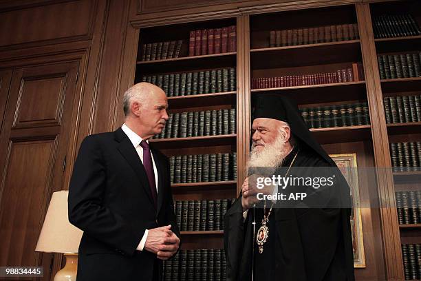 Greek Prmier George Papandreou speaks with Archbishop Ieronymos during their meeting in Athens on May 4, 2010. Greek stocks plunged more than five...