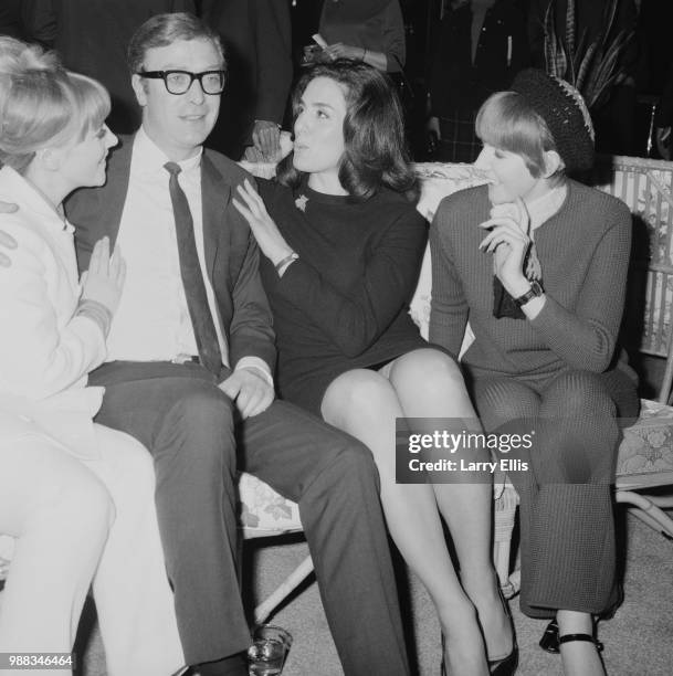 English actor Michael Caine pictured with, from left, Julia Foster, Eleanor Bron and Cilla Black at a function in London on 18th March 1966. Michael...