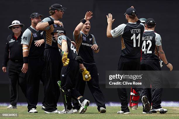 Nathan McCullum of New Zealand celebrates the wicket of Craig Ervine of Zimbabwe during the ICC T20 World Cup Group B match between New Zealand and...