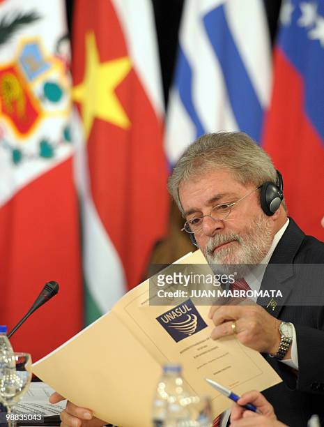 Brazilian President Luiz Inacio Lula da Silva reads a document during the opening session of the Union of South American Nations presidential summit...