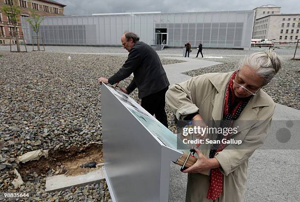Artisans affix an explanatory tablet outside the Topography of Terror documentation center and museum on May 4, 2010 in Berlin, Germany. The center,...