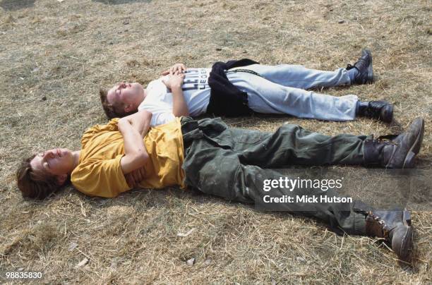 Two festival goers take a chance to relax at the Glastonbury Festival in June 1992.