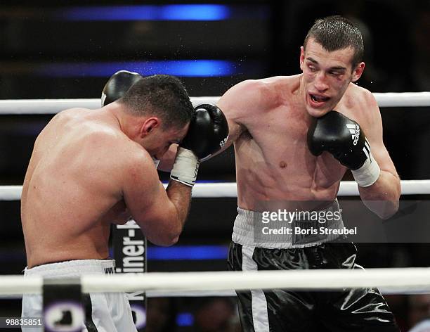 Karo Murat of Germany and Tommy Karpency of the U.S. Exchange punches during their WBO Intercontinental Light Heavyweight title fight at the...