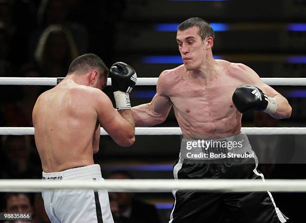 Karo Murat of Germany and Tommy Karpency of the U.S. Exchange punches during their WBO Intercontinental Light Heavyweight title fight at the...