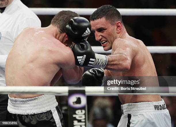 Karo Murat of Germany and Tommy Karpency of the U.S. Exchange punches during their WBO Intercontinental Light Heavyweight title fight at the...