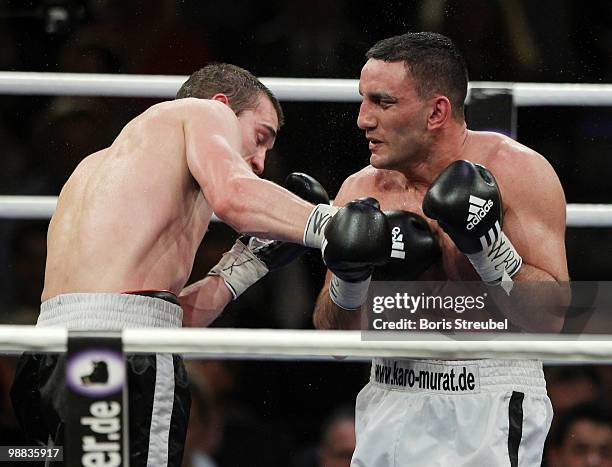 Karo Murat of Germany and Tommy Karpency of the U.S. Exchange punches during their WBO Intercontinental Light Heavyweight title fight at the...