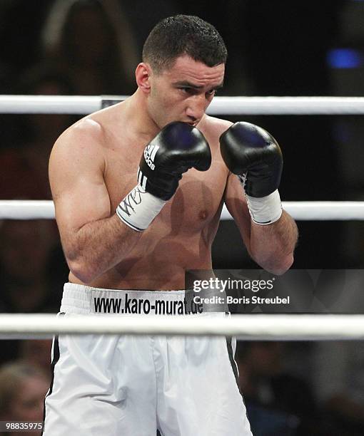 Karo Murat of Germany punches during his WBO Intercontinental Light Heavyweight title fight against Tommy Karpency of the U.S. At the Weser-Ems-Halle...