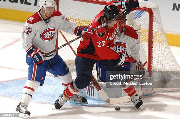 Mike Knuble of the Washington Capitals fights for a loose puck against Josh Gorges of the Montreal Canadiens during Game Seven of the Eastern...