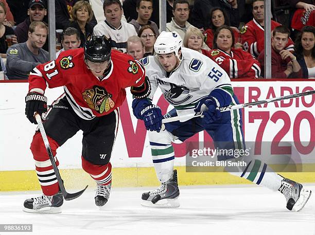 Marian Hossa of the Chicago Blackhawks and Shane O'Brien of the Vancouver Canucks watch the puck at Game One of the Western Conference Semifinals...