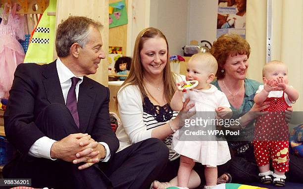 Former Prime Minister Tony Blair meets parents and children during a visit to Woodbank with Elton Children's Centre on May 4, 2010 in Bury, United...