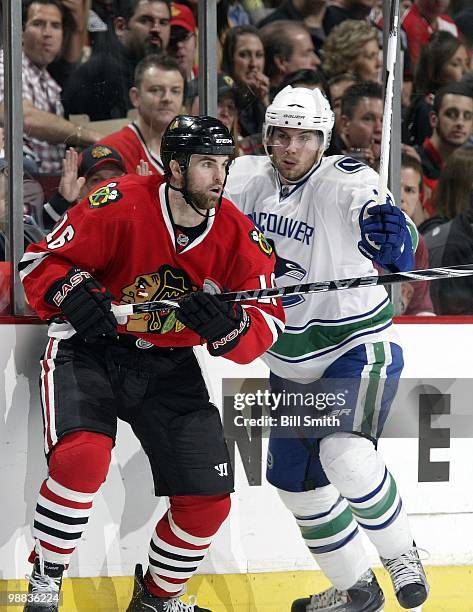 Andrew Ladd of the Chicago Blackhawks and Steve Bernier of the Vancouver Canucks watches for the puck at Game One of the Western Conference...