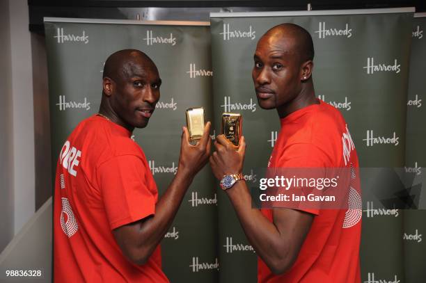 Sol Campbell and Carlton Cole attend a photocall to launch an exclusive ipod range in aid of the Bobby Moore Fund for Cancer Research at Harrods on...