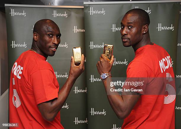 Sol Campbell and Carlton Cole attend a photocall to launch an exclusive ipod range in aid of the Bobby Moore Fund for Cancer Research at Harrods on...