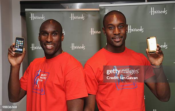 Sol Campbell and Carlton Cole attend a photocall to launch an exclusive ipod range in aid of the Bobby Moore Fund for Cancer Research at Harrods on...