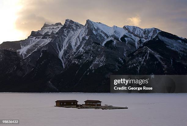 Boathouse stands locked in ice on a frozen Lake Minnewanka as seen in this 2010 Banff Springs, Canada, early morning landscape photo.