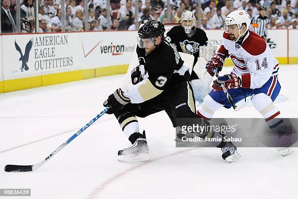 Alex Goligoski of the Pittsburgh Penguins skates with the puck as Tomas Plekanec of the Montreal Canadiens pursues in Game Two of the Eastern...